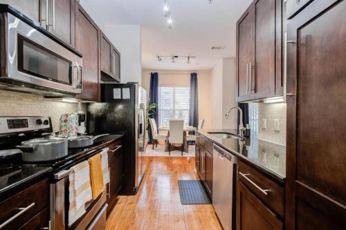 a kitchen with wooden floors and wooden cabinets at Smoke Free Amazing Modern 1 BD near NRG in Houston