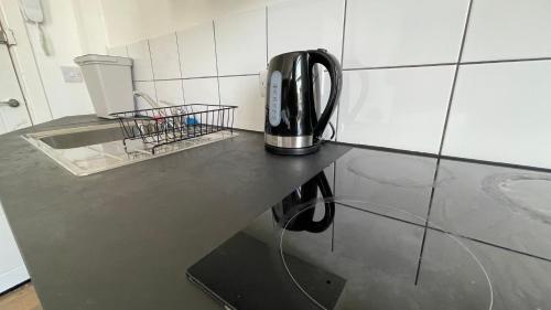 a coffee maker sitting on a counter in a kitchen at Lovely studio flat in the heart of Holloway. in London