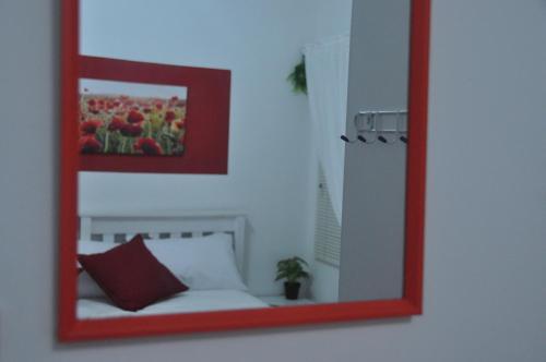 a mirror on a wall with a couch in a room at Smartie Box in Langebaan