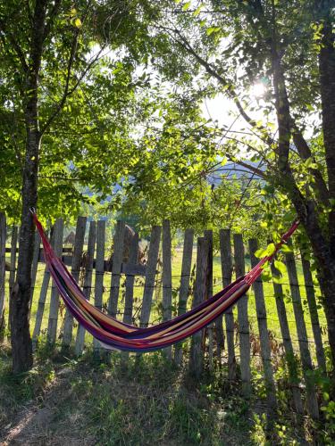 a hammock hanging on a wooden fence at Hygge Cabana in Malaia