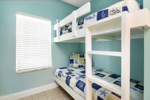a bedroom with a bunk bed and a window at Spacious, cozy 2brd /2bath condo - LakeTown Wharf in Panama City Beach