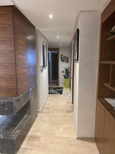 a hallway of a home with a stone fireplace at Luxury apartment 2 in Casablanca