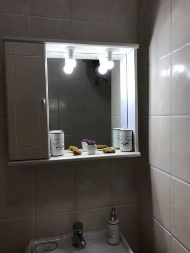 a bathroom with a sink and a mirror and a sink at amazing apartment in the heart of masouri in Masouri
