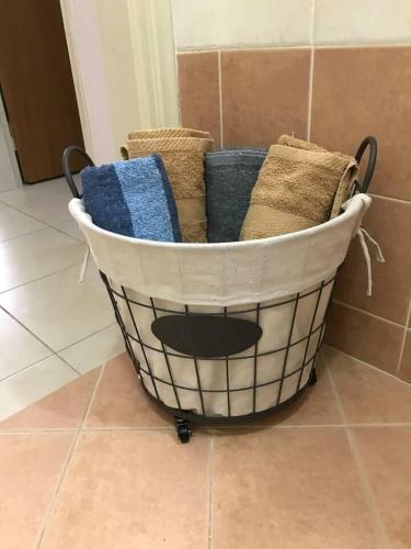 a basket filled with towels on a tiled floor at amazing apartment in the heart of masouri in Masouri
