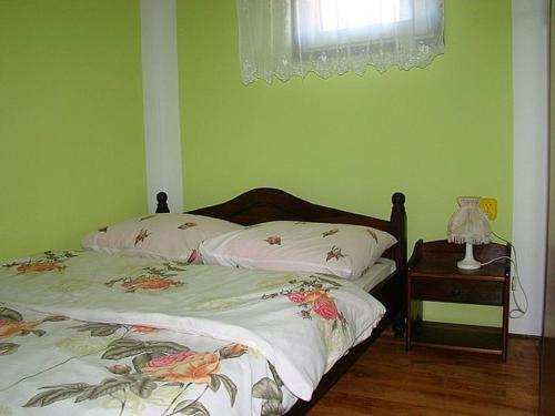 a bedroom with two beds and a table with a lamp at Rancho Zawóz domek nr5 in Zawóz