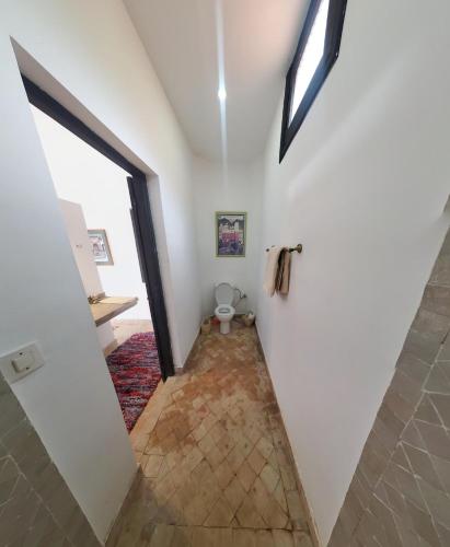 a hallway of a house with a door and a toilet at ourika oufla in Ourika
