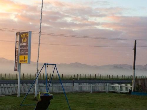a person playing on a swing set on the side of the road at North End Motel in Huntly