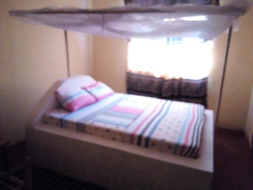 Ένα ή περισσότερα κρεβάτια σε δωμάτιο στο Mgeni Homestay