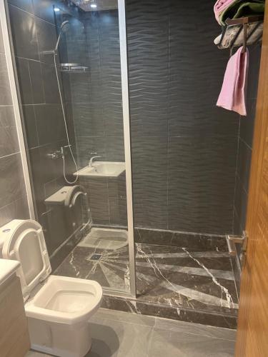 a bathroom with a shower and a toilet and a sink at Luxury apartment 2 in Casablanca