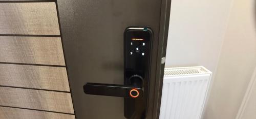 a refrigerator door with a red light on it at EM02- Apartament 2 camere luxury in Târgu Jiu