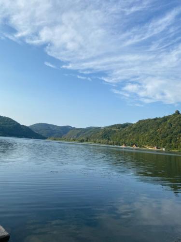a large body of water with mountains in the background at Dijanin Konak in Zvornik