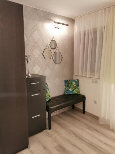 a room with a bench and a dresser in a room at Májusfa in Balatonszárszó
