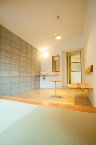 a room with a table in the middle of a room at Kinsui Annex in Toyooka