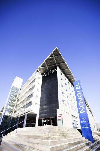 a building with a sign in front of it at Novotel Belfort Centre Atria in Belfort