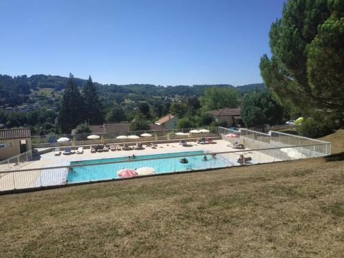 ein großer Swimmingpool mit Liegen und Sonnenschirmen in der Unterkunft SWANARA HOLIDAYS in Sarlat-la-Canéda