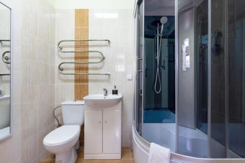 a bathroom with a toilet and a sink and a shower at Avanti apgyvendinimas-restoranas in Biržai