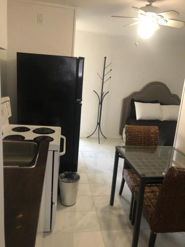 a kitchen with a stove and a table and a couch at Sage Hills Motel in Cache Creek