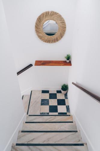 a stairway with a mirror and a checkered floor at Ferrel Village Home in Ferrel