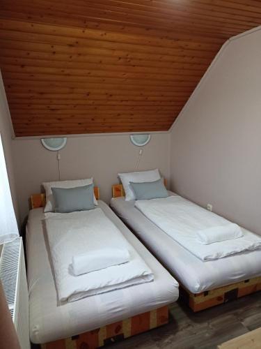 A bed or beds in a room at Marcell Apartman