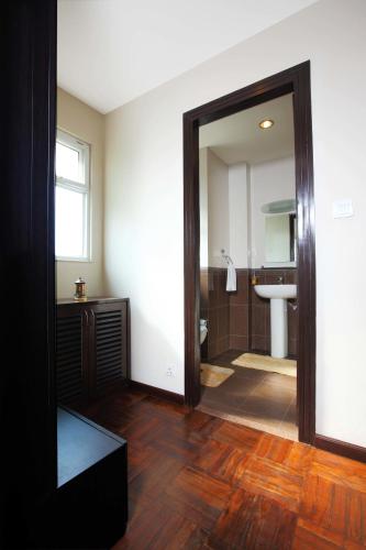 a bathroom with a large mirror and a sink at Retreat Serviced Apartment in Kathmandu