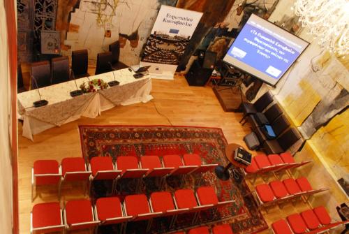 an overhead view of a stage with red chairs and a screen at Leventis Art Suites in Panayítsa