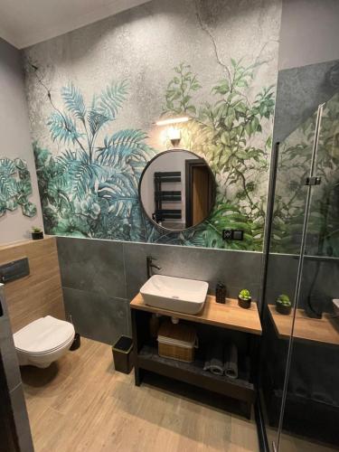 W łazience znajduje się umywalka i lustro. w obiekcie Apartament z jacuzzi w centrum Sanoka w mieście Sanok