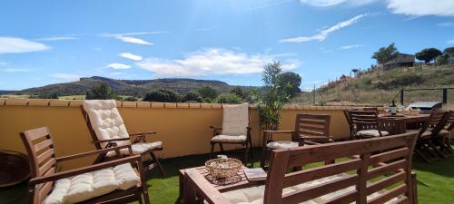 a patio with chairs and tables with a view of mountains at LA CASA DE FUENTETOBA in Fuentetoba
