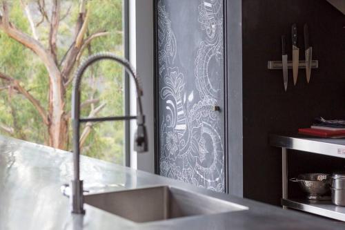 a kitchen counter with a sink and a window at Luxurious, Tranquil and Private in Lindisfarne