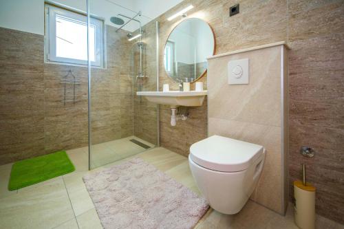 a bathroom with a toilet and a sink and a shower at Ve & Ki in Podstrana