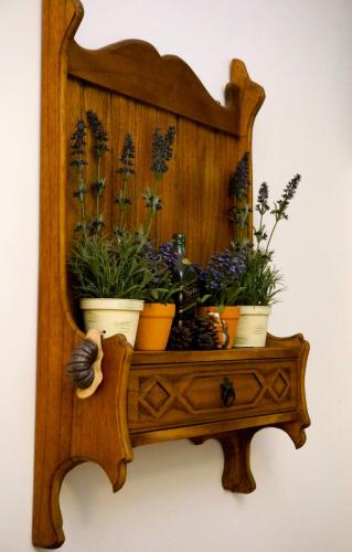 a wooden shelf with potted plants on it at Hope & Sea Homestay in Hualien City