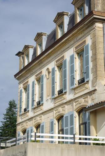 a building with blue shutters on it at Le Clocher in Saint-Julien