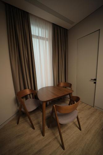 a room with a table and chairs and a window at AVENUE RESIDENCE by AY North Avenue in Yerevan