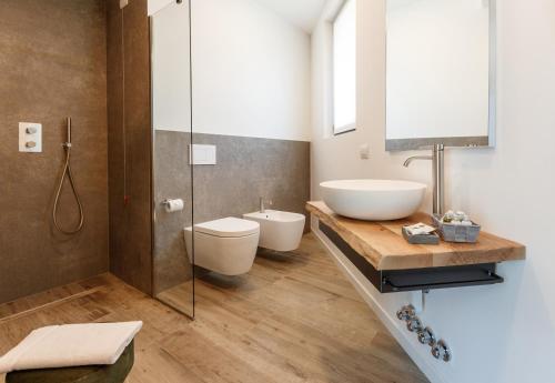 a bathroom with a sink and a toilet at Nebbiolo Wine B&B in Castione Andevenno