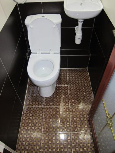 a bathroom with a toilet and a sink at Australia Lounge in Hong Kong