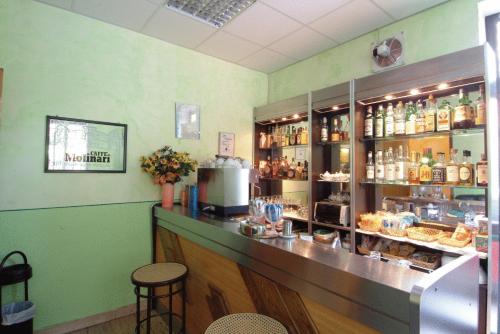 a bar in a restaurant with a counter at Hotel San Geminiano in Modena