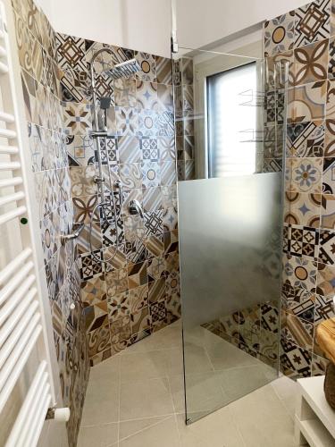 a shower with a glass door in a bathroom at Villa Sofia *Luxury experience in Calabria in Zambrone