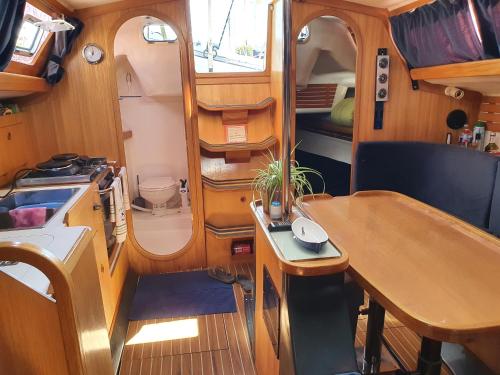 a small kitchen and a table in a boat at Voilier CALYPSO in La Rochelle