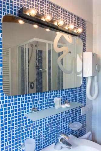 a bathroom with a mirror and a sink at Minihotel IRIS in Maiori