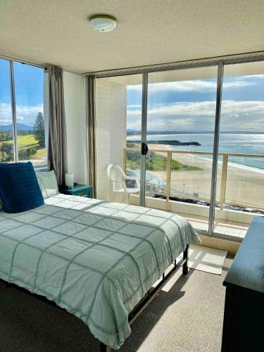 a bedroom with a bed and a view of the ocean at Ebbtide 29 - All linen supplied Bunk linen provided for self-making in Forster