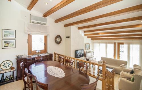 a dining room with a wooden table and chairs at Lovely Home In Santa Cristina D'aro in Santa Cristina d'Aro