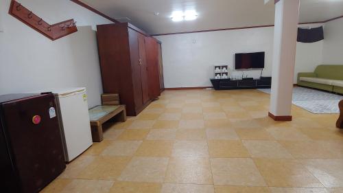 a large room with a kitchen and a living room at The Red House in Sokcho