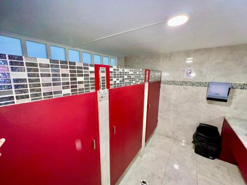 a bathroom with red doors and a tv on the wall at Downtown Treasure Place in Mexico City