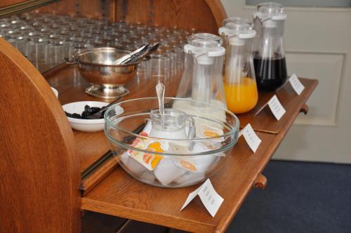 a wooden table with a bowl of food on it at Stadshotel de Graafschap in Doetinchem