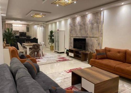 a living room with a couch and a fireplace at Unique Seaview 3-Bedroom Apartment in Alexandria