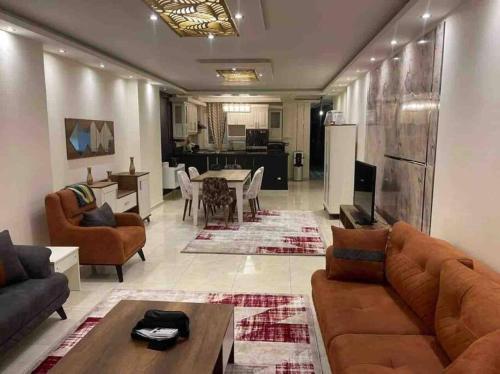 a living room with couches and a dining room at Unique Seaview 3-Bedroom Apartment in Alexandria