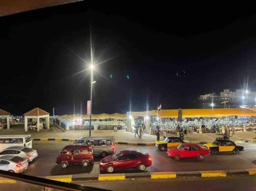 a parking lot at night with cars parked in it at Unique Seaview 3-Bedroom Apartment in Alexandria