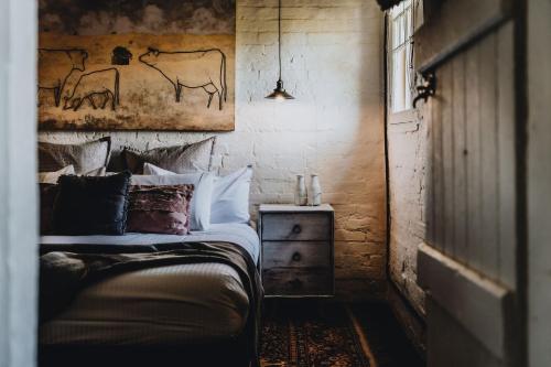 a bedroom with a bed and a painting on the wall at The Dairy in Castlemaine