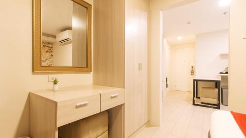a bathroom with a dresser and a mirror on the wall at RedDoorz Plus at La Belle Residences Makati City in Manila