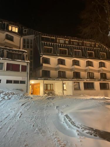 a building in the snow in front of a building at Foemina in Faidello