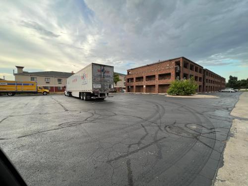 a semi truck is parked in a parking lot at Motel 6 Oklahoma City OK Fairgrounds West in Oklahoma City